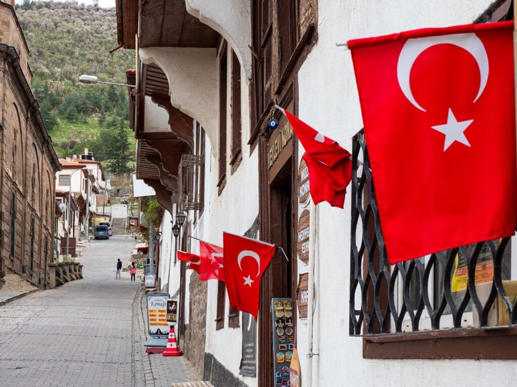 Picturesque street view in Turkey adorned with Turkish flags on a quaint day.